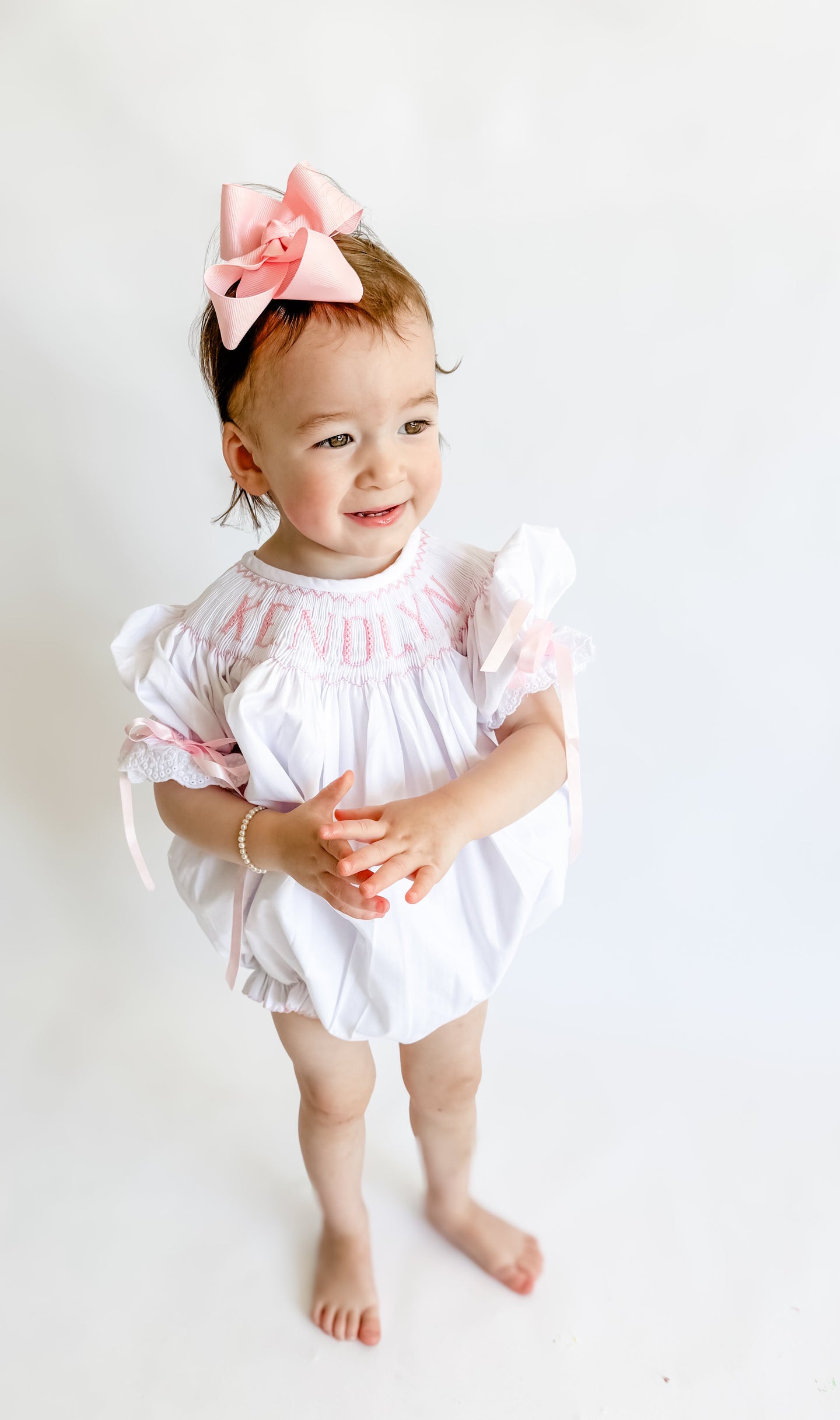 Girls I’m Yours; White w/ Pink Name Smocked Bubble